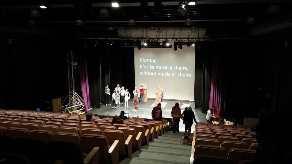 Stuart supporting students in a theatre environment